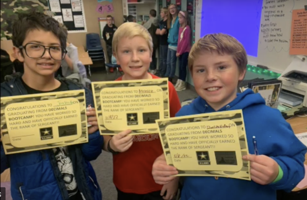 Students display their certificates