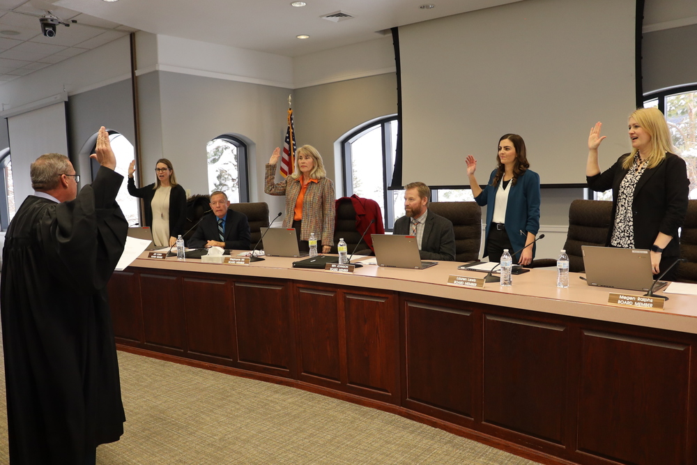 Judge Brent Dunlap leads the swearing in for four board members