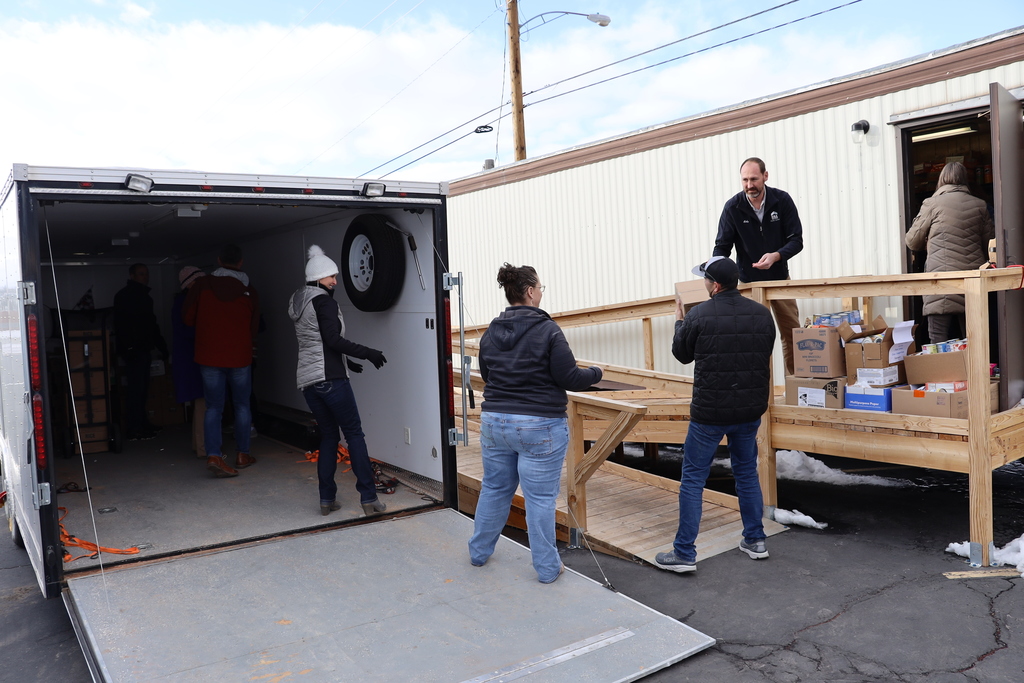 Iron County Board of Realtors members load up a trailer with food to be distributed to students.