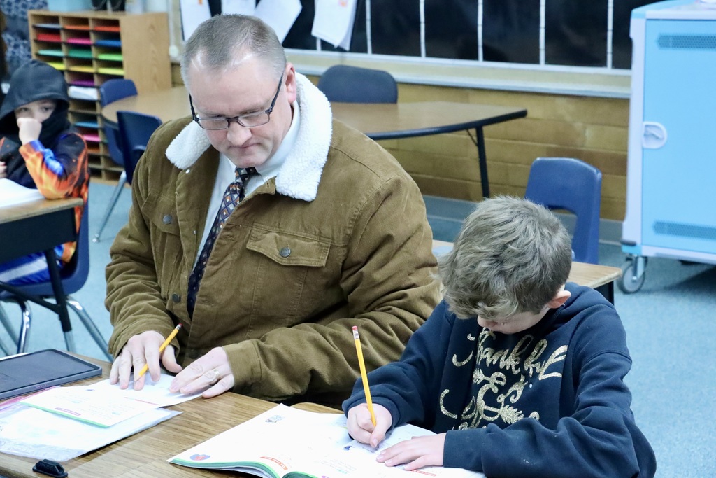Superintendent Dr. Lance Hatch works with a student.