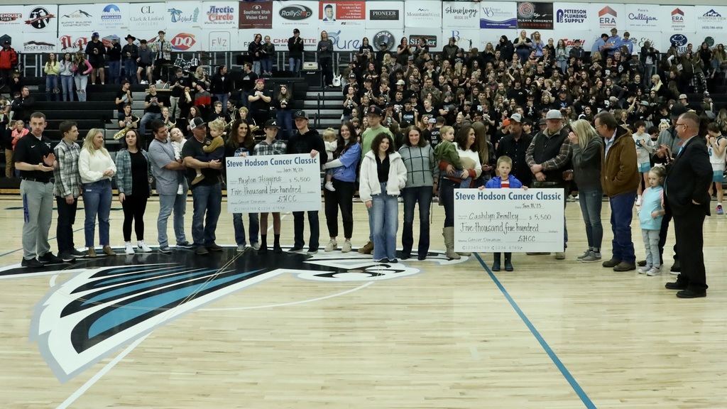 Family members receive two checks at Canyon View High School. 