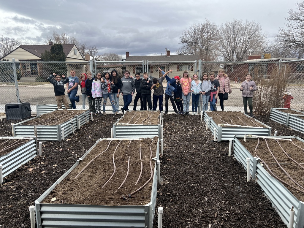 The school garden is prepared.  Several students are in the background.